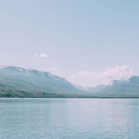 a lake with mountains in the background